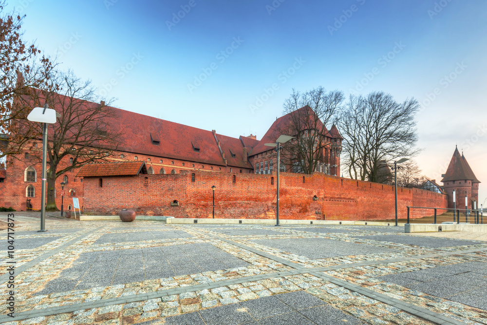 The Castle of the Teutonic Order in Malbork at sunset, Poland