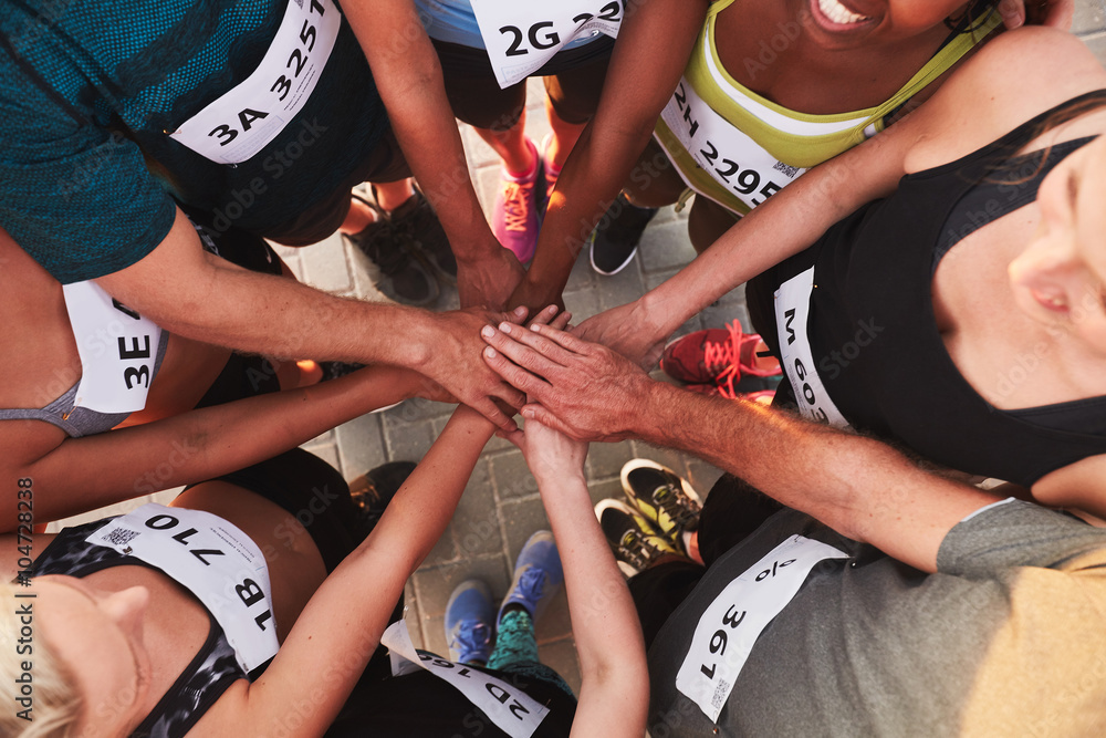 Team with hands together after competition