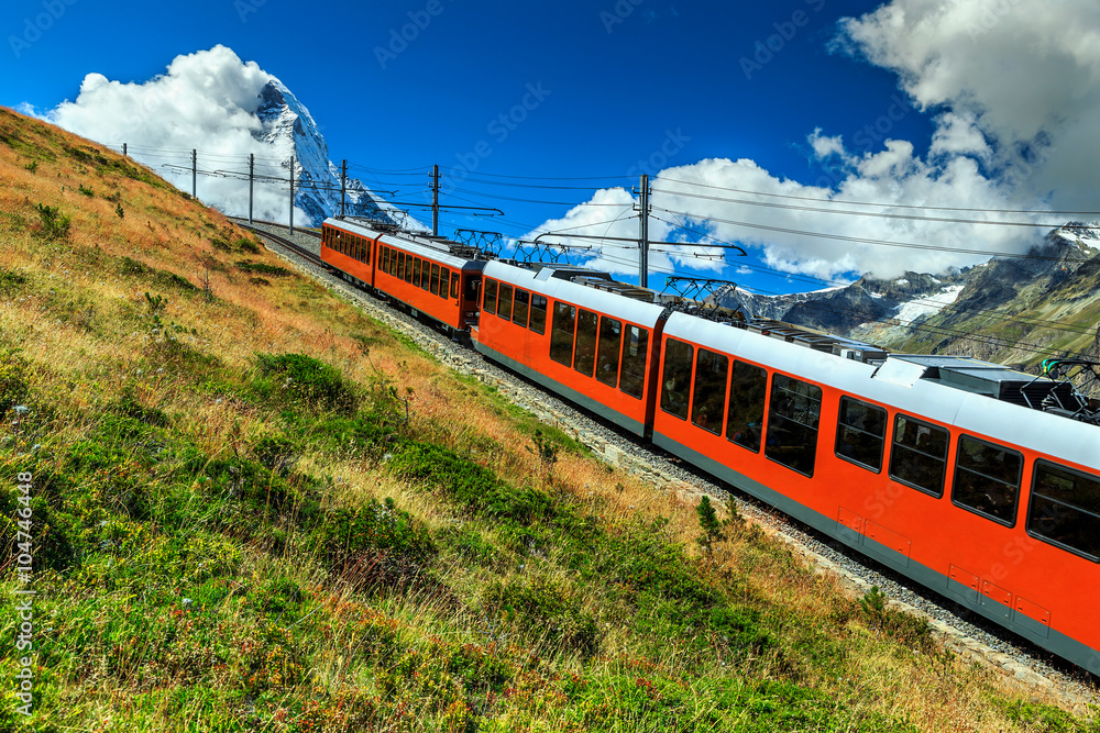 Electric tourist train and famous misty Matterhorn peak,Switzerland,Europe