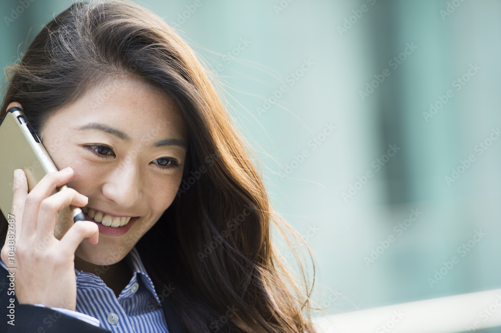 Young woman wearing a suit is make a phone call