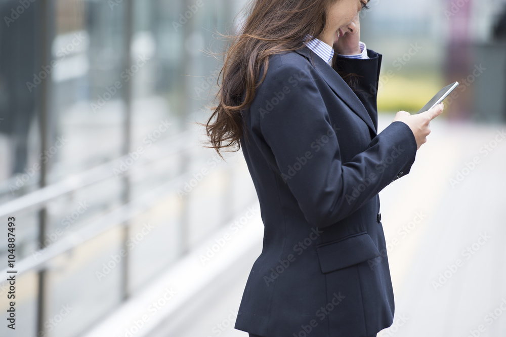 Women wearing the suit have a smartphone