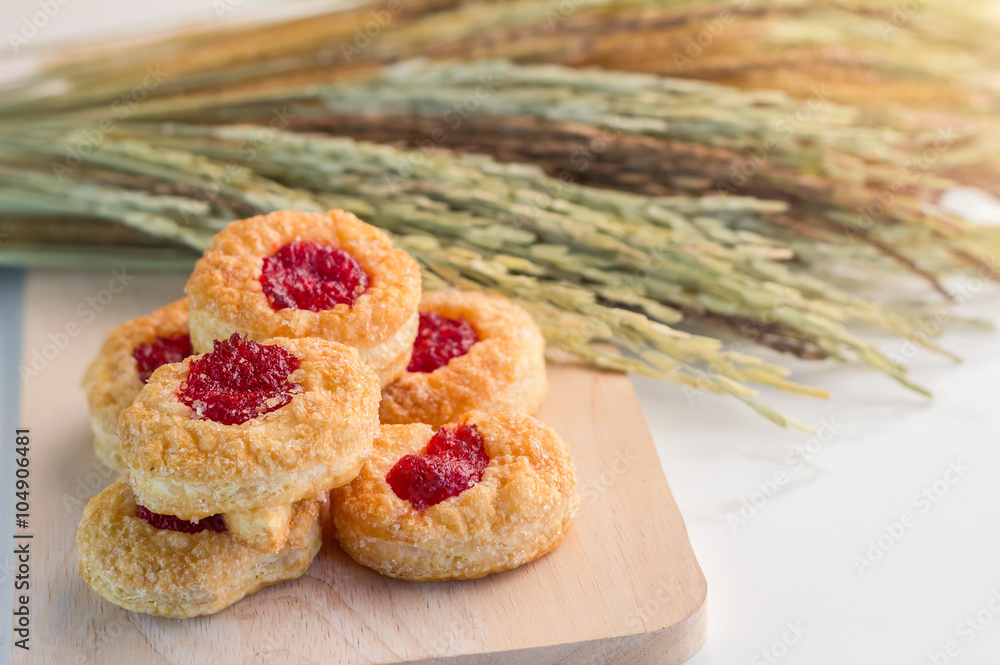 Homemade biscuits with Wheat Ears on wooden board with wood spoon.jpg