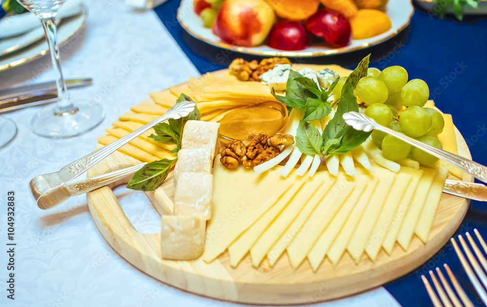 Cheese plate with cheeses in serving on the table