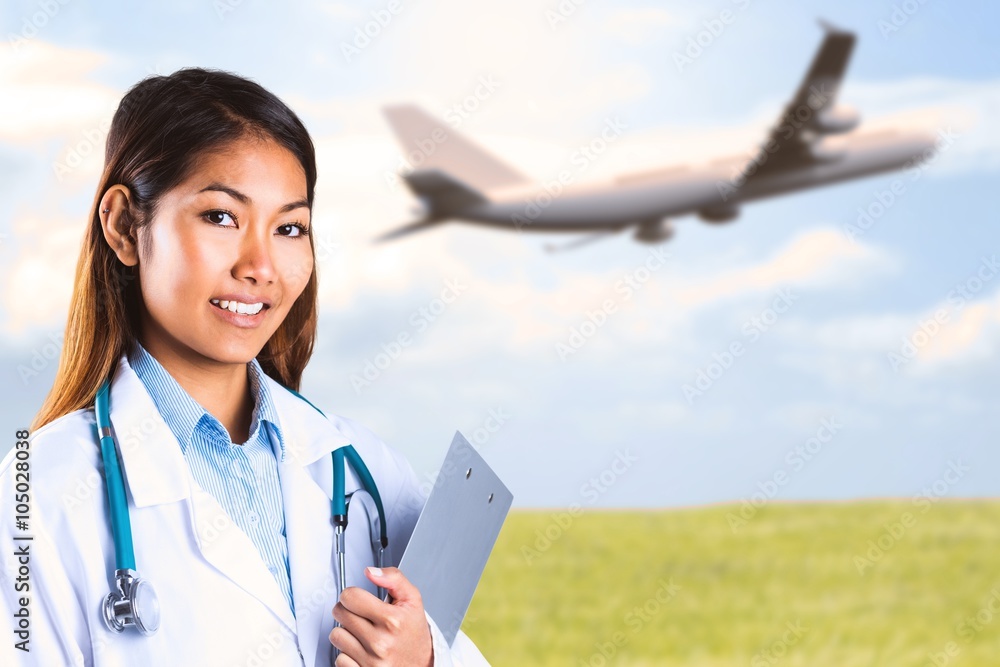 Composite image of asian doctor holding clipboard