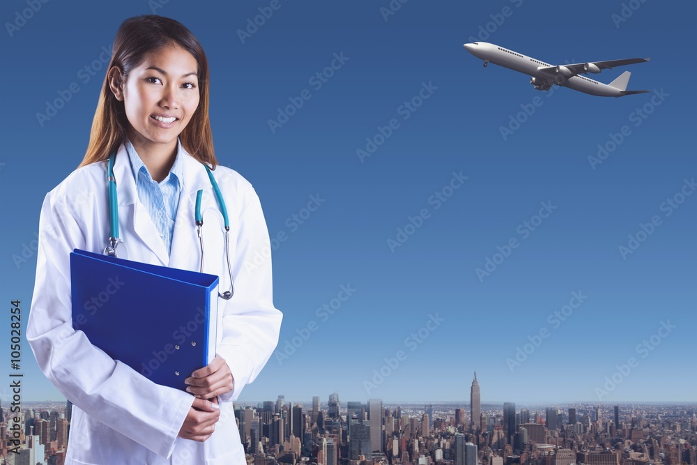 Composite image of asian doctor holding blue binder