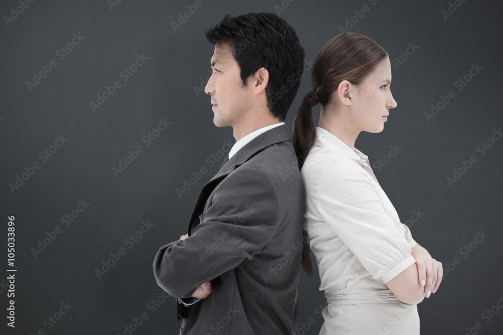 Composite image of business people standing back to back