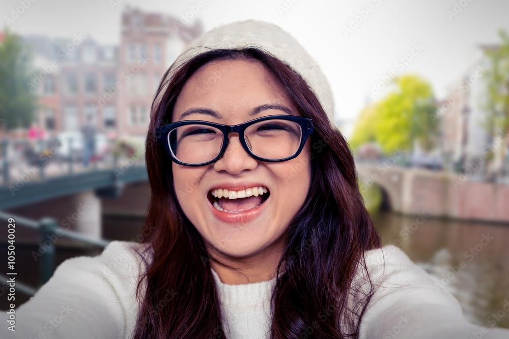 Composite image of asian woman smiling at the camera