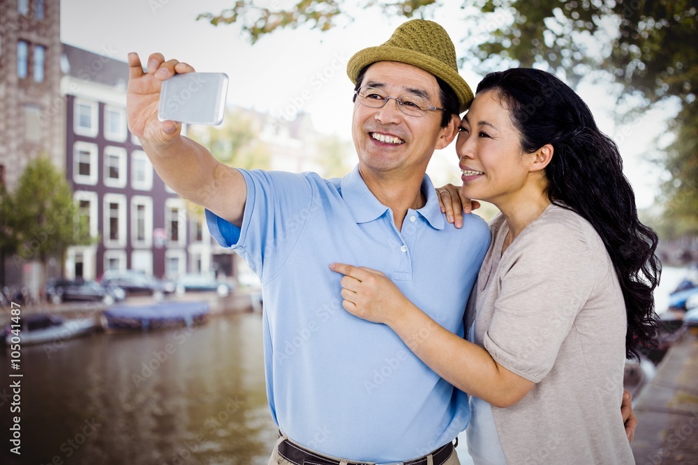 Composite image of man and woman taking a picture