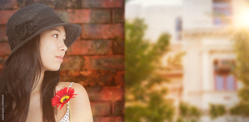 Composite image of cheerful woman with flower 