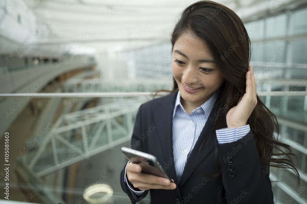 Woman who was wearing a suit you are using a smartphone