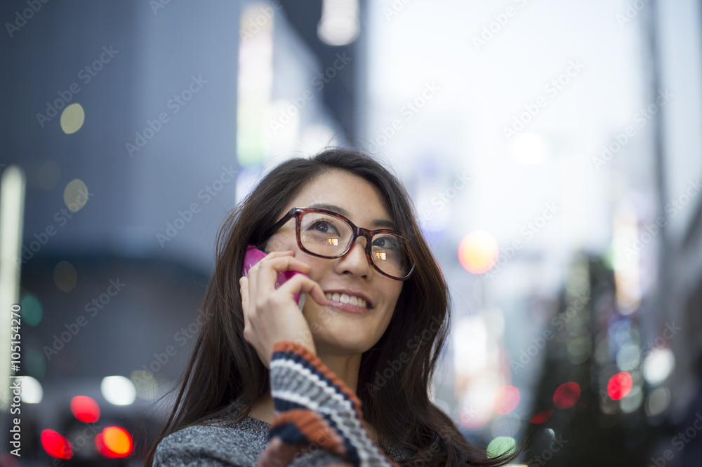 Young women are over the phone outside