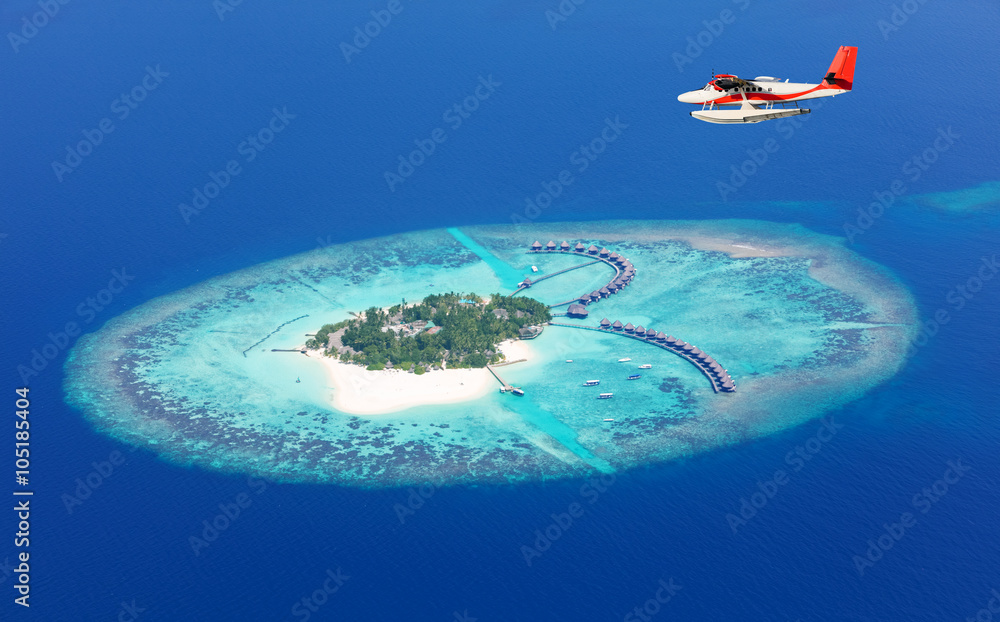 Sea plane flying above Maldives islands