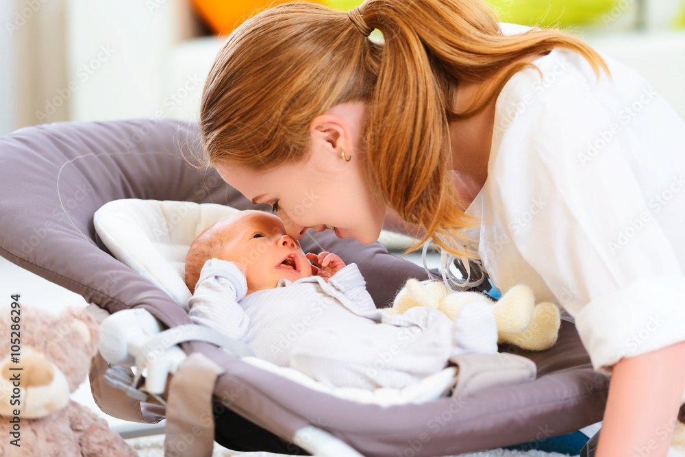 happy family. mother plays with newborn baby