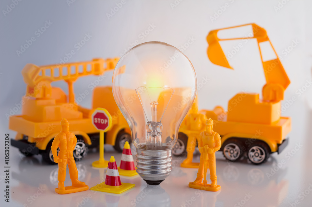 Creative business concept with light bulb and workmen figure