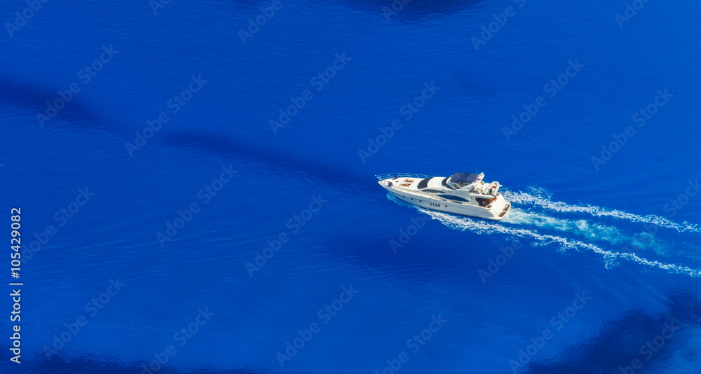 Aerial view of single yacht in azure sea