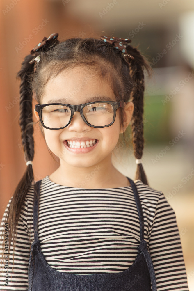 Cute Little girl with glasses feeling happy