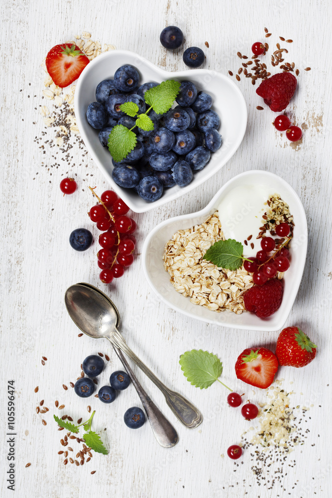 Healthy breakfast of muesli, berries with yogurt and seeds