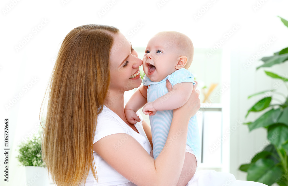 happy family mother playing  with baby