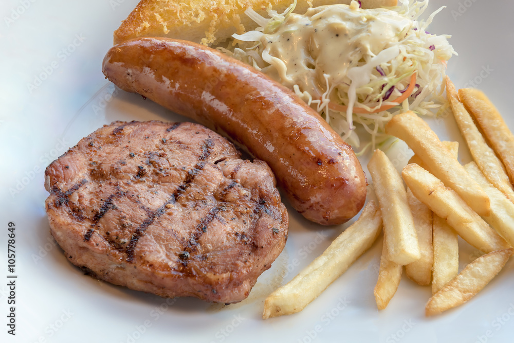 Grilled steak, French fries and vegetables