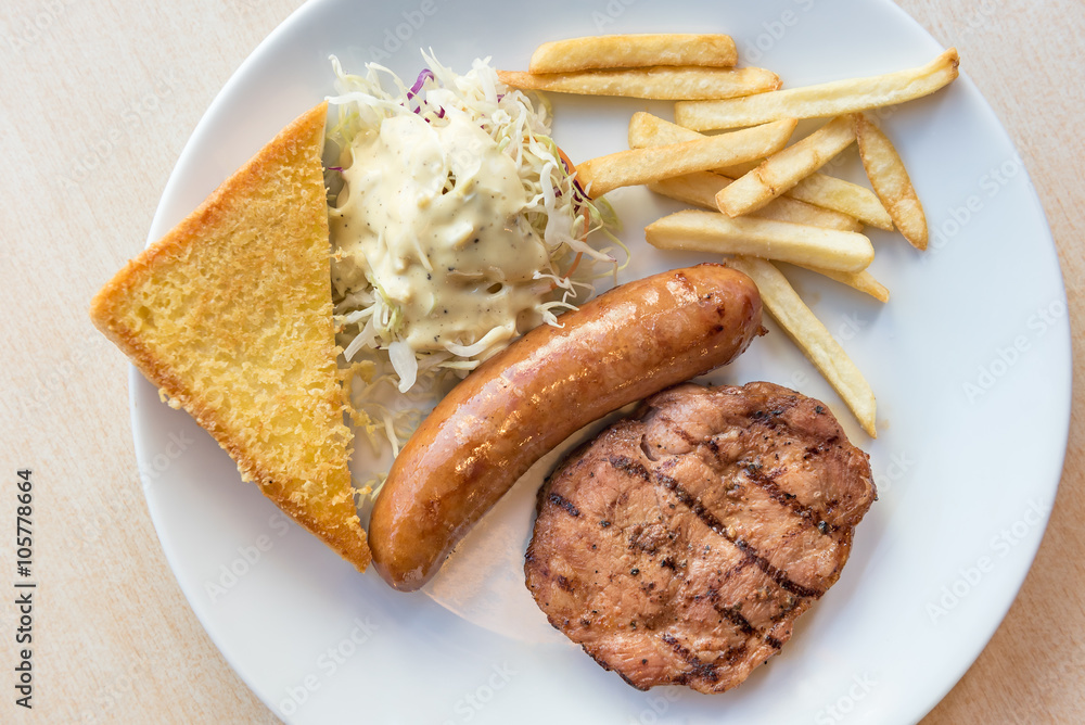 Grilled steak, French fries and vegetables