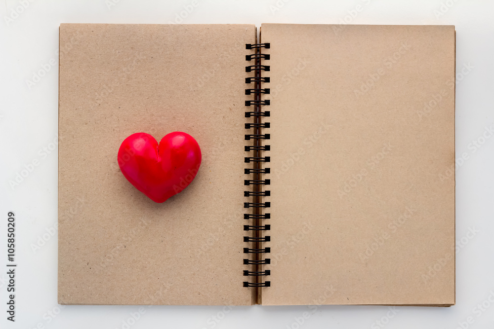 Blank open notebook with red heart