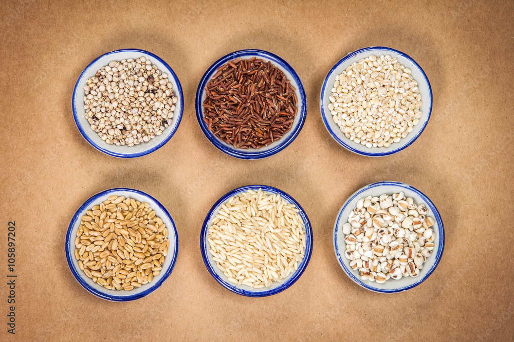 The Variety  of grain rice in cup on natural brown papaer 