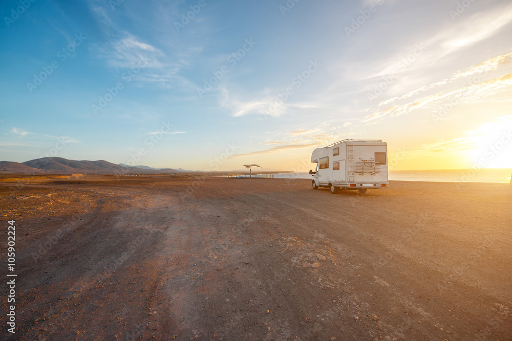 Deserted landscape with camping vehicle on Fuerteventura island in Spain. Wide angle view with copy 