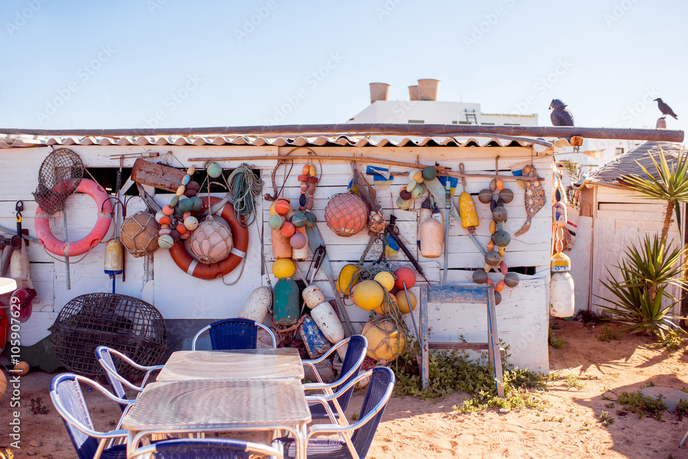 Fishing tools hanging on the white wall outdoors