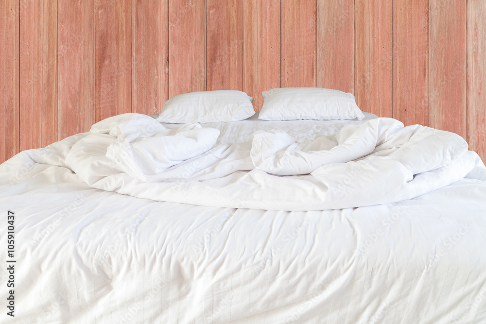 White bedding sheets and pillow .