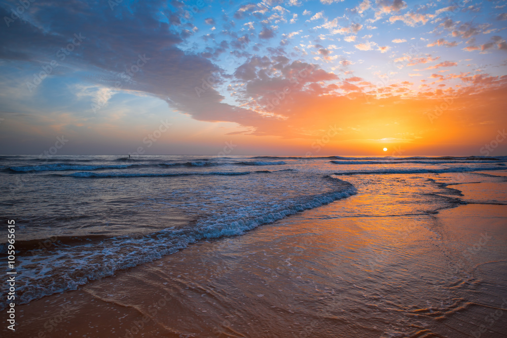 Beach with glossy surface reflecting beautiful seascape on the sunset in Maspalomas on Gran Canaria 