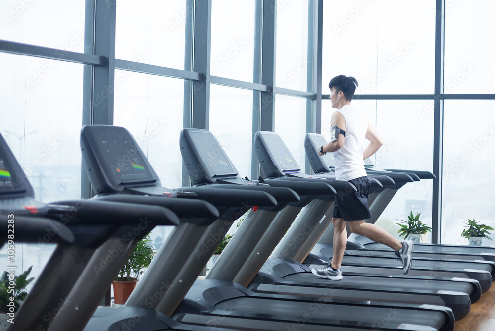 young handsome man works out in modern gym