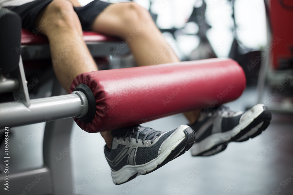 young handsome man works out in modern gym