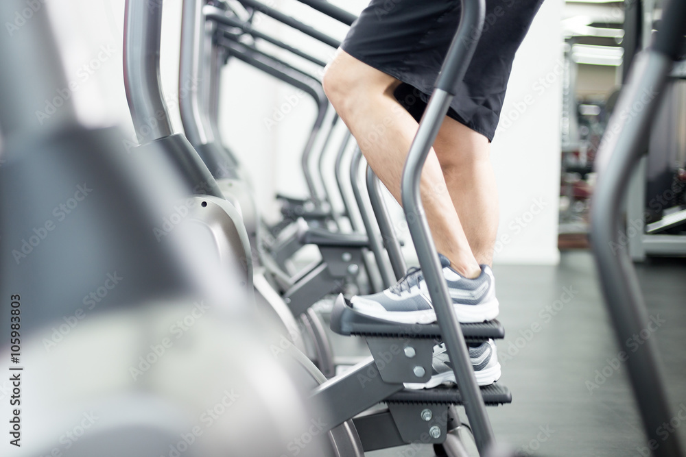 young handsome man works out in modern gym