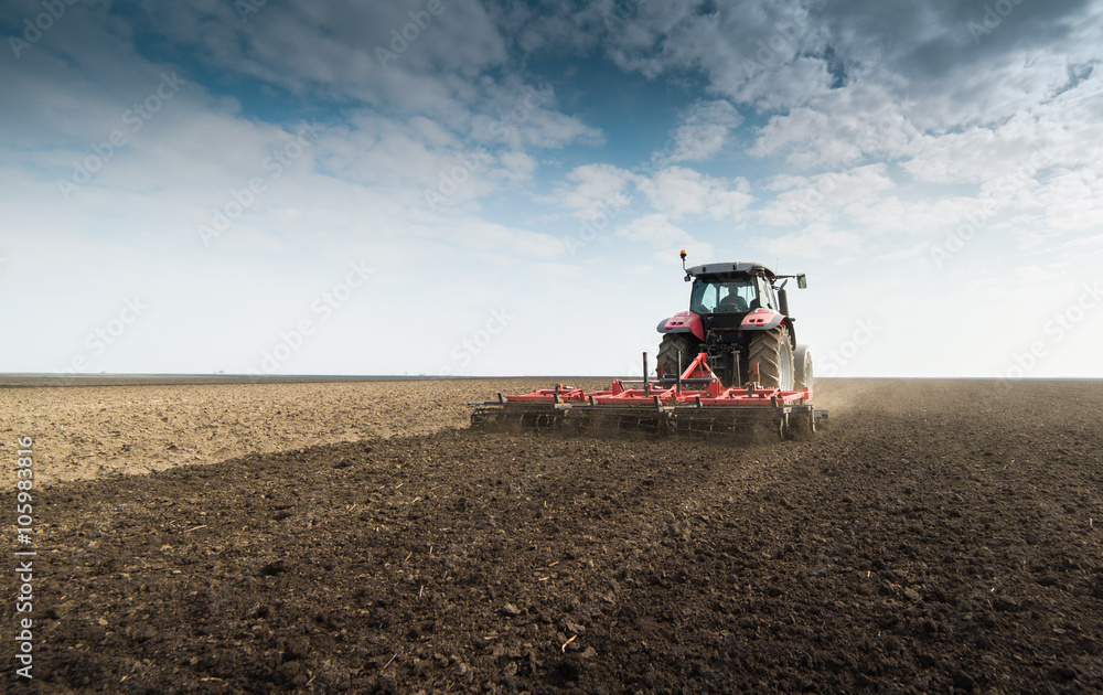 Tractor preparing land