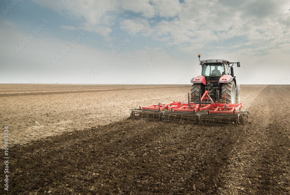 Tractor preparing land