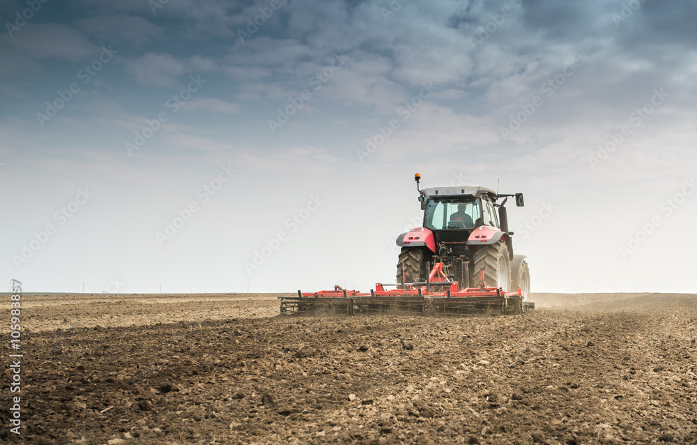 Tractor preparing land