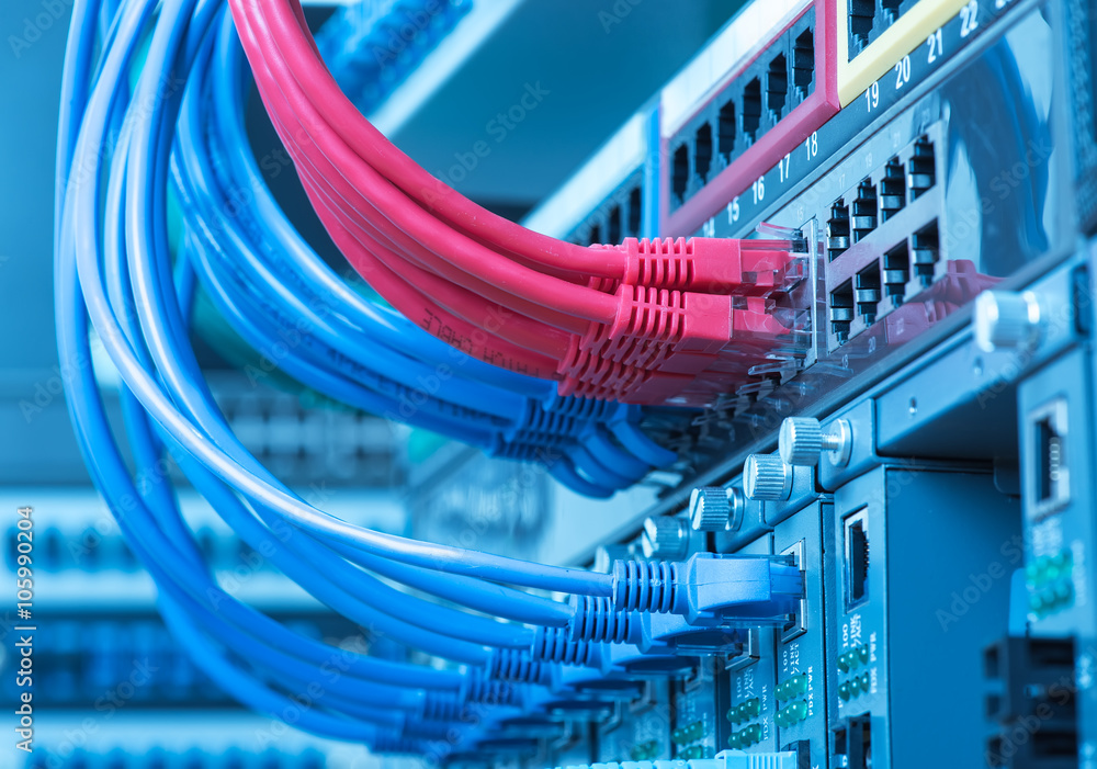 network cables and hub closeup with fiber optical background