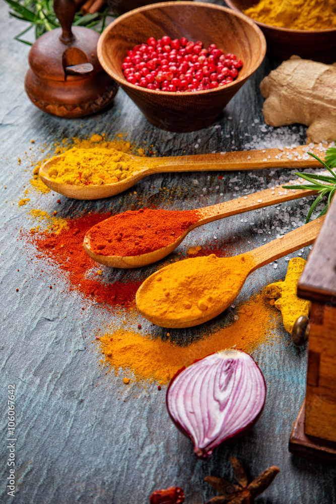 Various spices on black stone