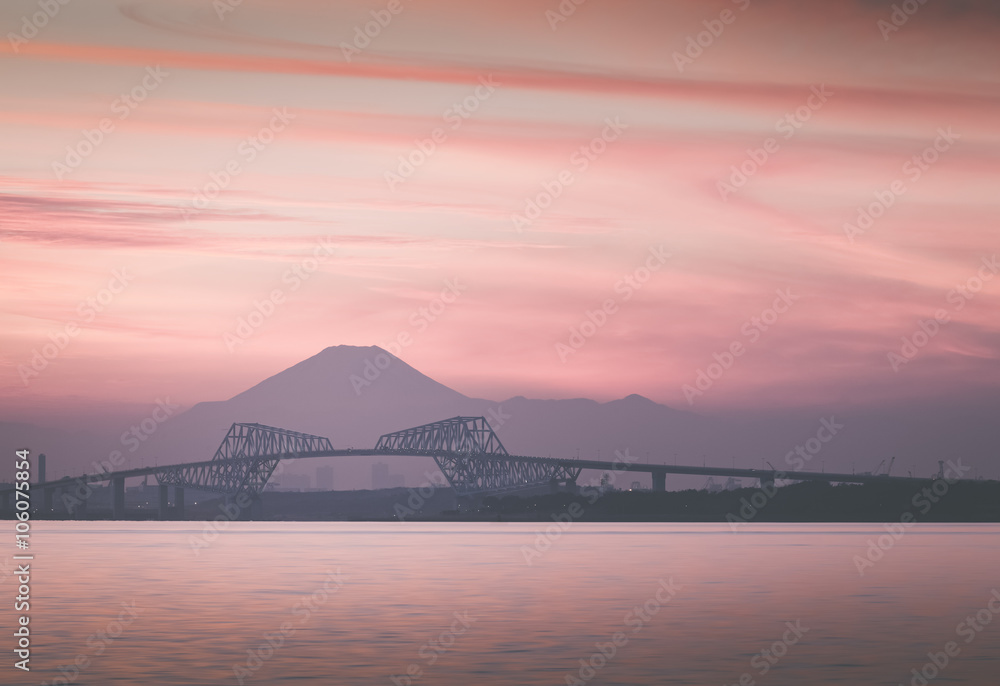 Tokyo bay at sunset with Tokyo gate bridge and Mountain Fuji .