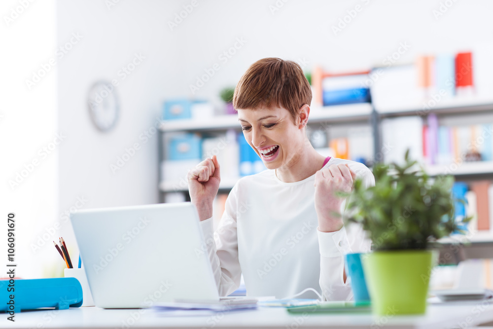 Cheerful businesswoman working with a laptop