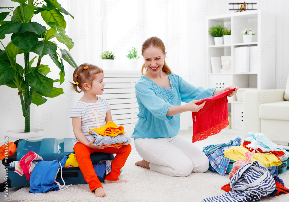 happy family mother and child daughter suitcases packed for vaca