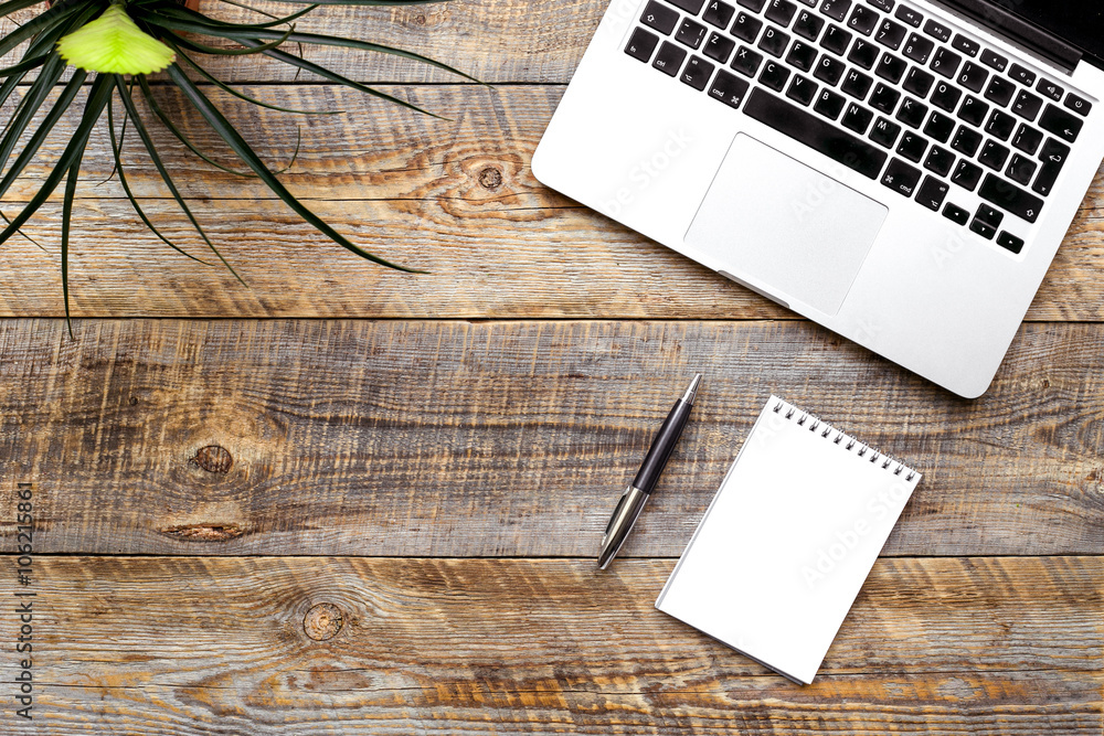 Comfortable working place at wooden table with laptop