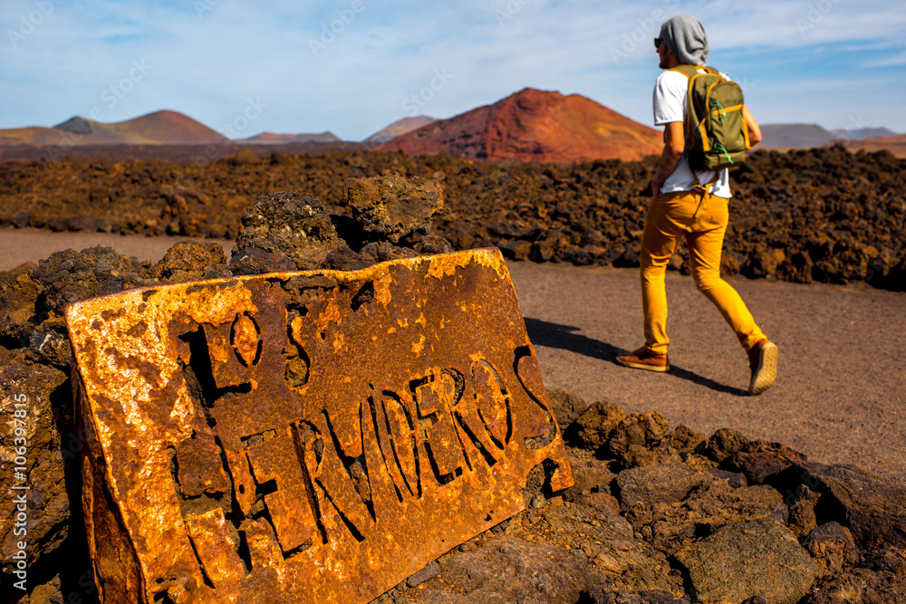 Man walking to Los Hervideros landmark on Lanzarote island