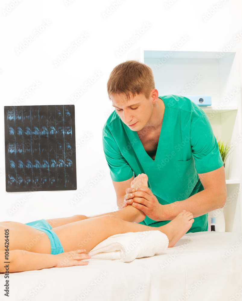 Massage therapist performing therapy 