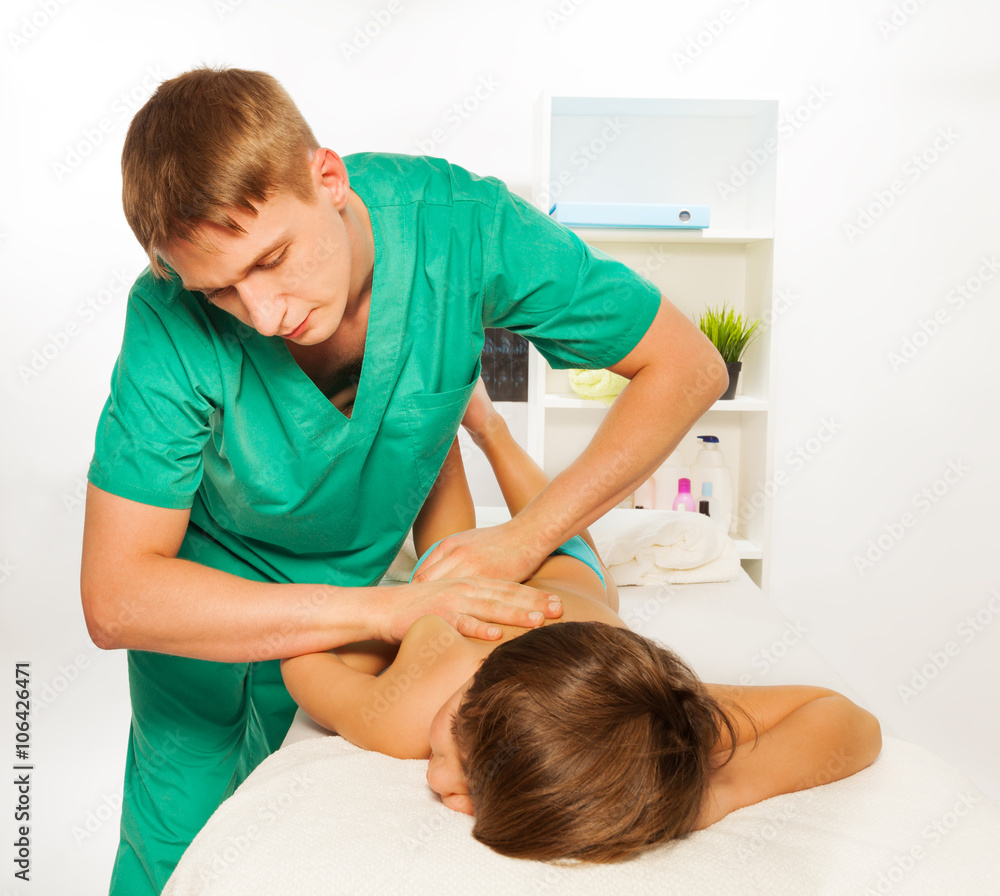 Close up of therapist doing massage on child leg