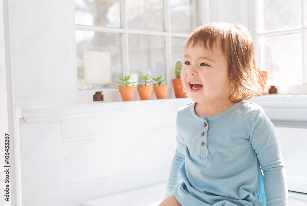  Happy toddler smiling in her house