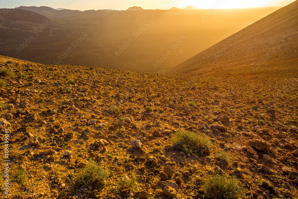 Volcanic landscape on the top of Caldera Blanca volcano on the sunset on Lanzarote island in Spain