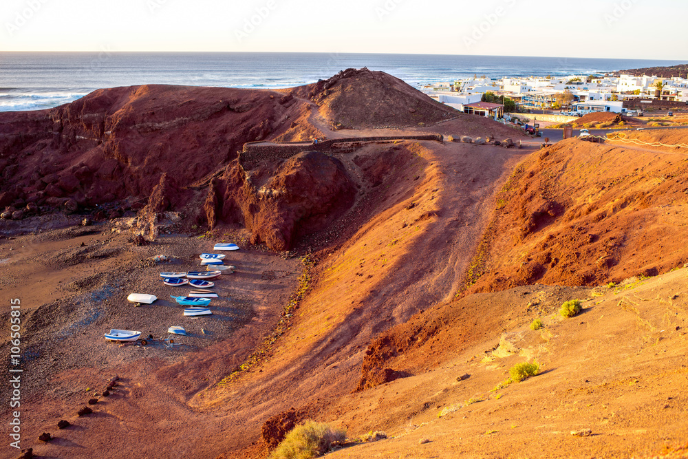 El Golfo bay with fishing boats on the sunset on Lanzarote island in Spain