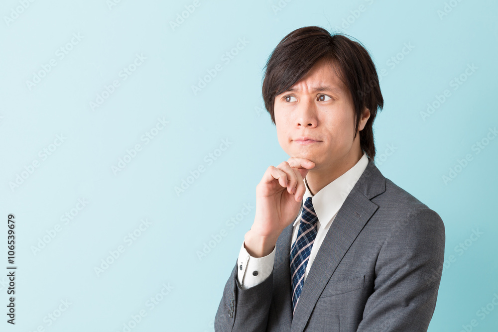 portrait of asian businessman on blue background