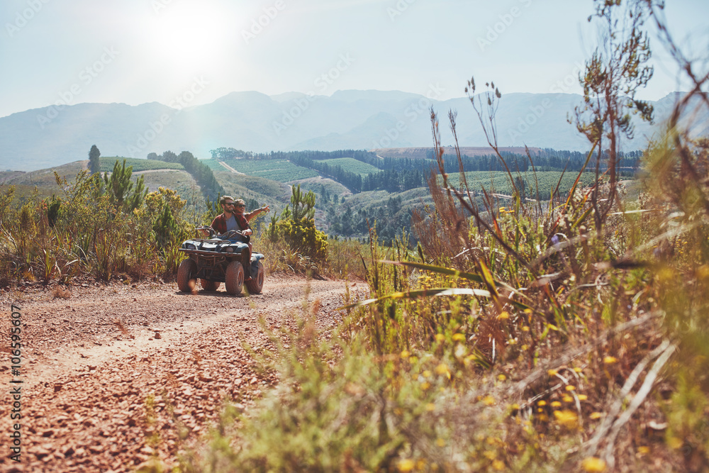 Young couple having fun on quad bike